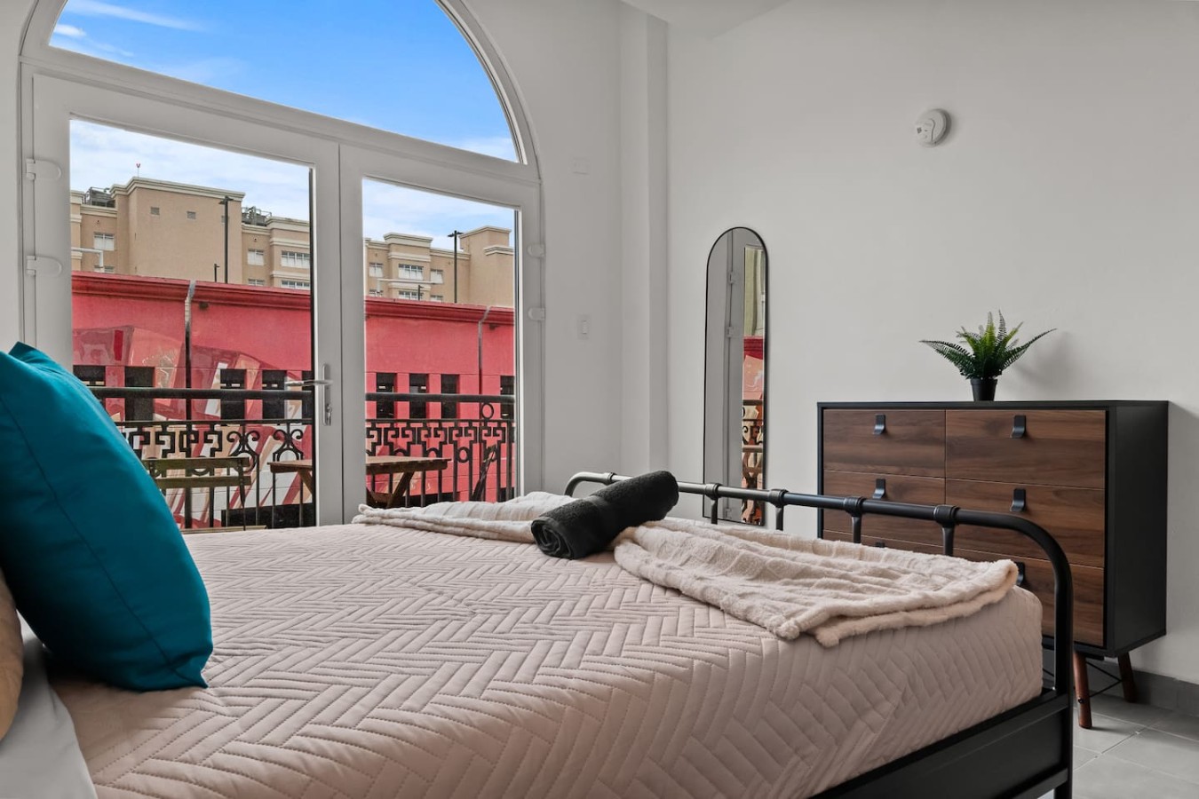 Bedroom with a large bed and a view of the city — Grand Galleria — Old San Juan Private Patio, Old San Juan