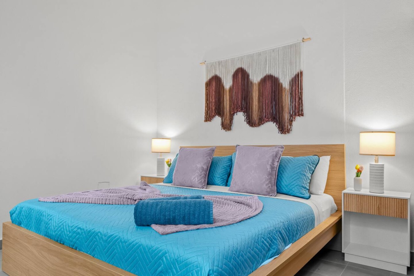 Bedroom with a blue bedspread and a purple throw blanket — Casa Valencia | Old San Juan, Old San Juan
