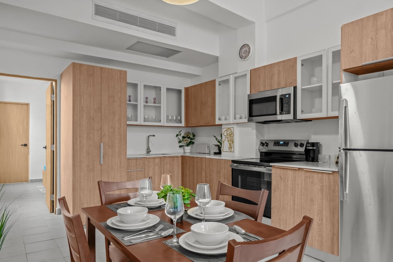 Dining room table with chairs and a vase of flowers on it — Casa Valencia | Old San Juan, Old San Juan