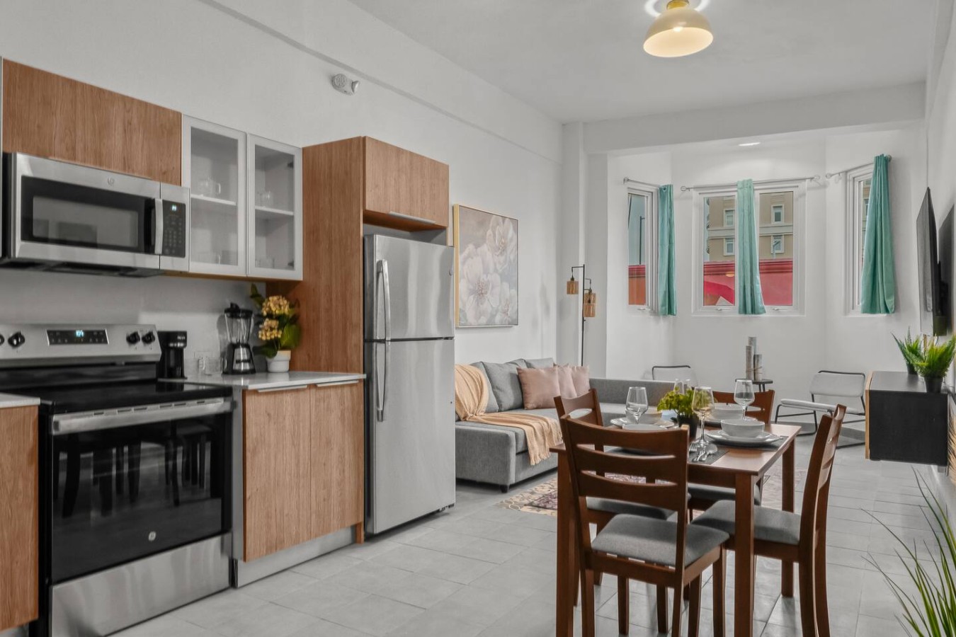 Kitchen with a refrigerator, sink, and a vase of flowers on the counter — Casa Valencia | Old San Juan, Old San Juan