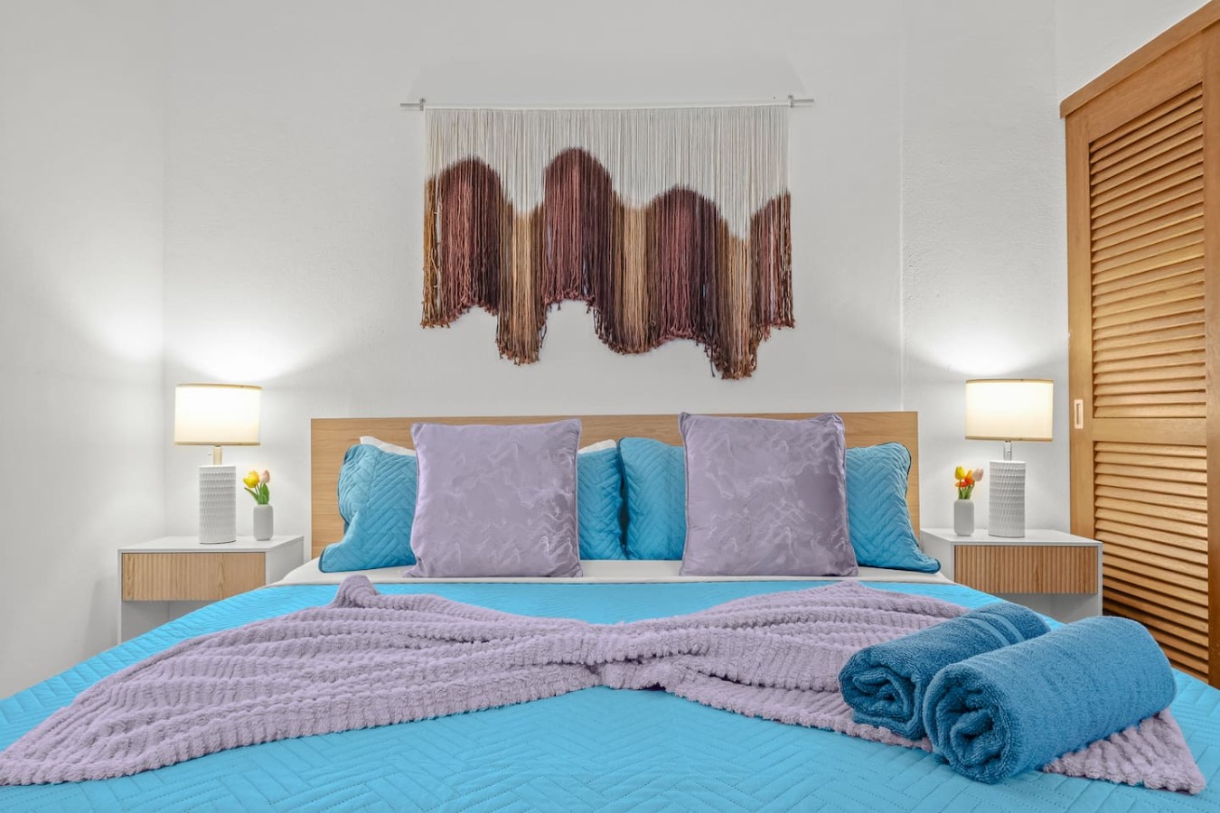 Bedroom with a blue bedspread and a purple blanket — Casa Valencia | Old San Juan, Old San Juan