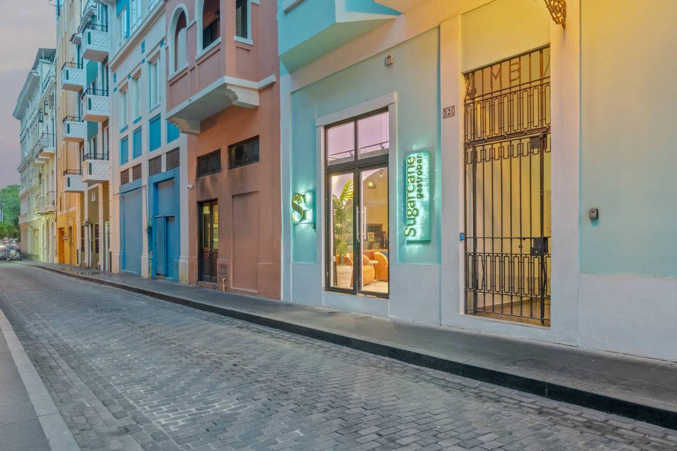 Exterior of a building with a blue door and a pink wall — Casa Valencia | Old San Juan, Old San Juan