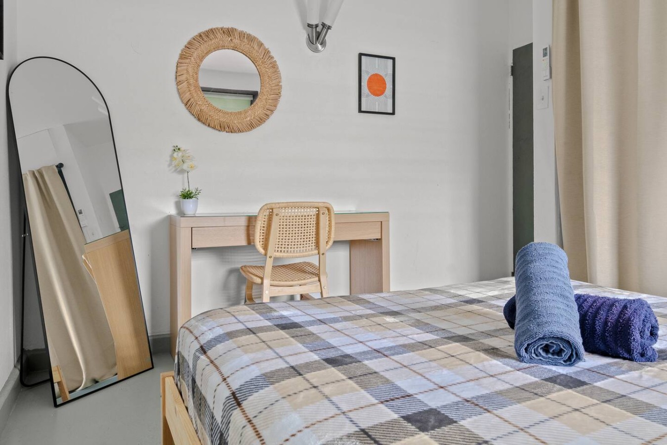 Bedroom with a bed, a chair, and a mirror on the wall — Santurce Blue 2BR | Near Beach & La Placita