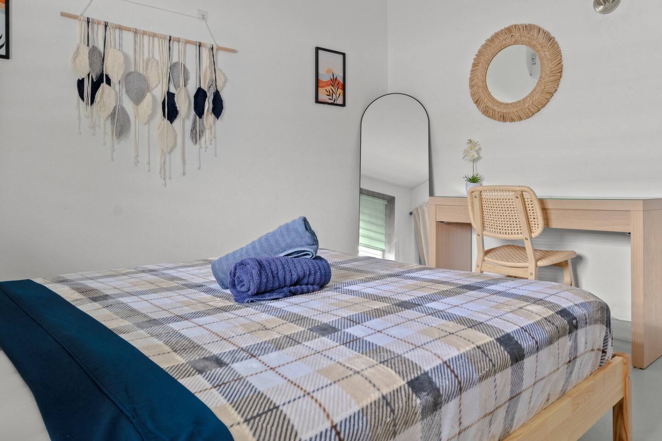 Bedroom with a blue plaid bedspread and a mirror on the wall — Santurce Blue 2BR | Near Beach & La Placita