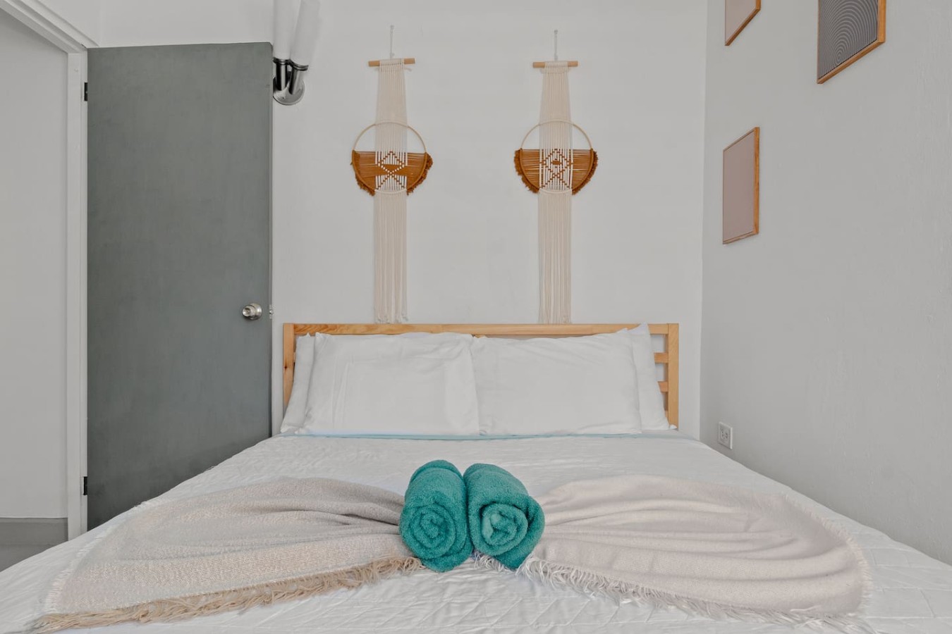 Bedroom with a bed and two blue towels on it — Santurce Blue 2BR | Near Beach & La Placita