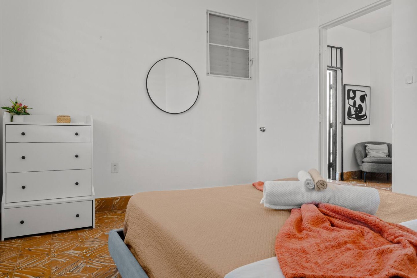 Bedroom with a bed, a mirror, and a window — Aurelia | Three Bedrooms in the Heart of San Juan, Santurce