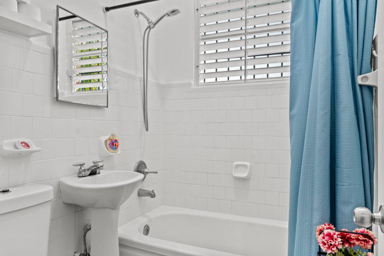 Bathroom with a tub and shower and a pedestal sink — Aurelia | Three Bedrooms in the Heart of San Juan, Santurce