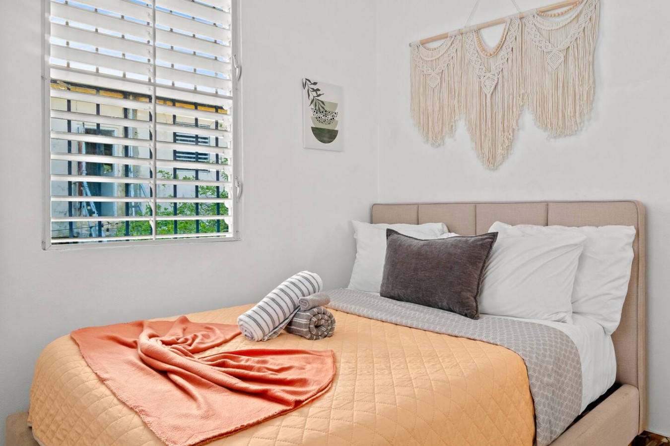 Bedroom with a bed, a chair, and a window — Aurelia | Three Bedrooms in the Heart of San Juan, Santurce