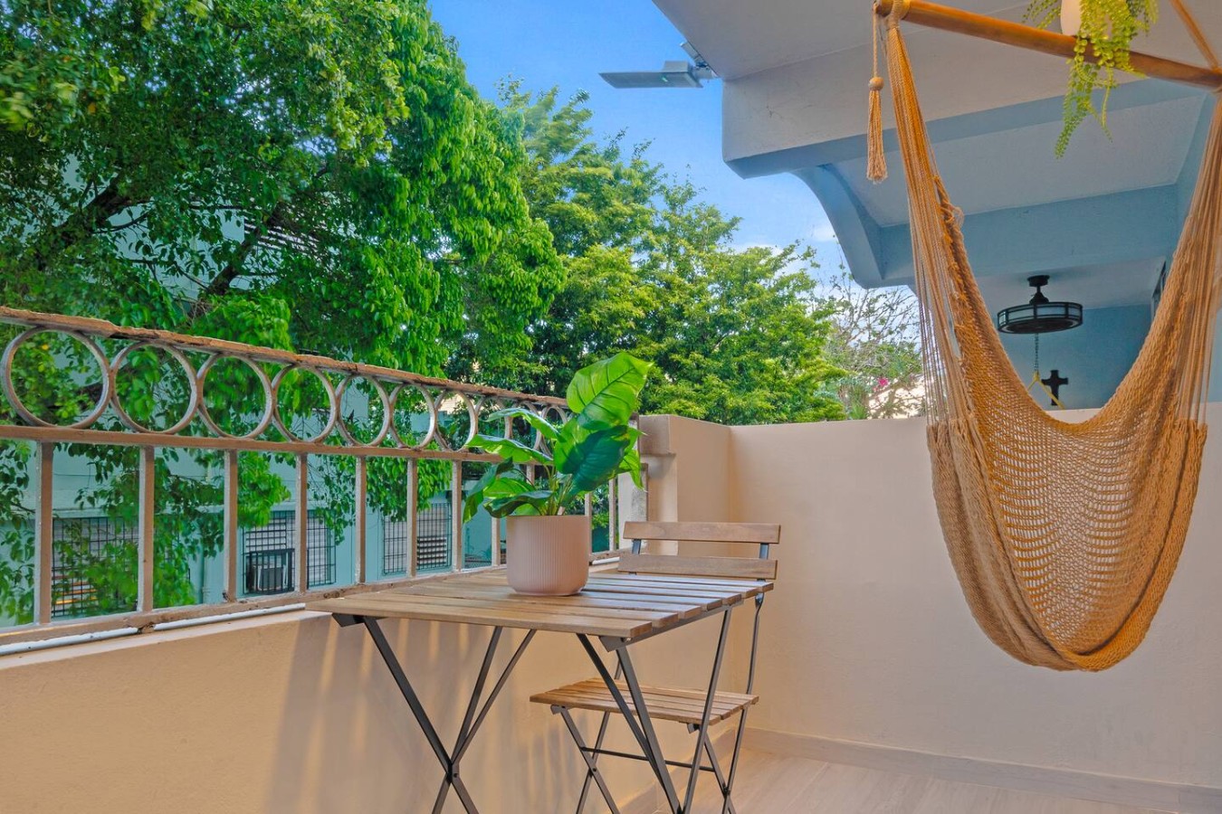 Balcony with a hammock and a potted plant — San Juan 2BR | Sleeps 7 + Balcony & Laundry, Santurce