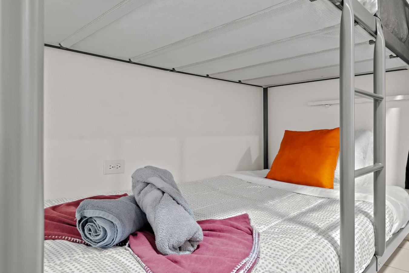 Bedroom with a bed, pillows, and towels — The Castillo | Sleeps 8 | 2BR + Backyard & Parking, Santurce