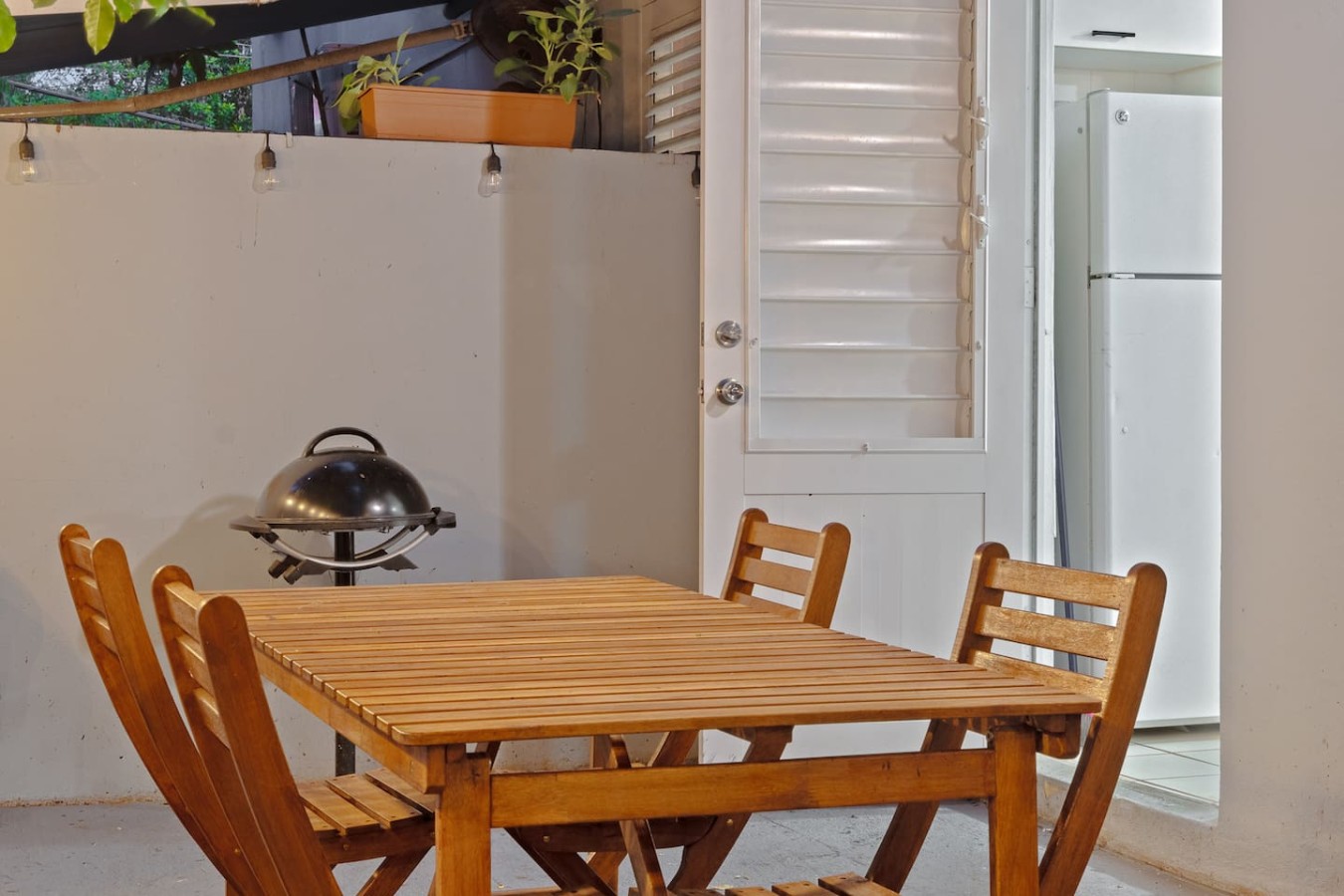 Wooden dining table with chairs — The Castillo | Sleeps 8 | 2BR + Backyard & Parking, Santurce