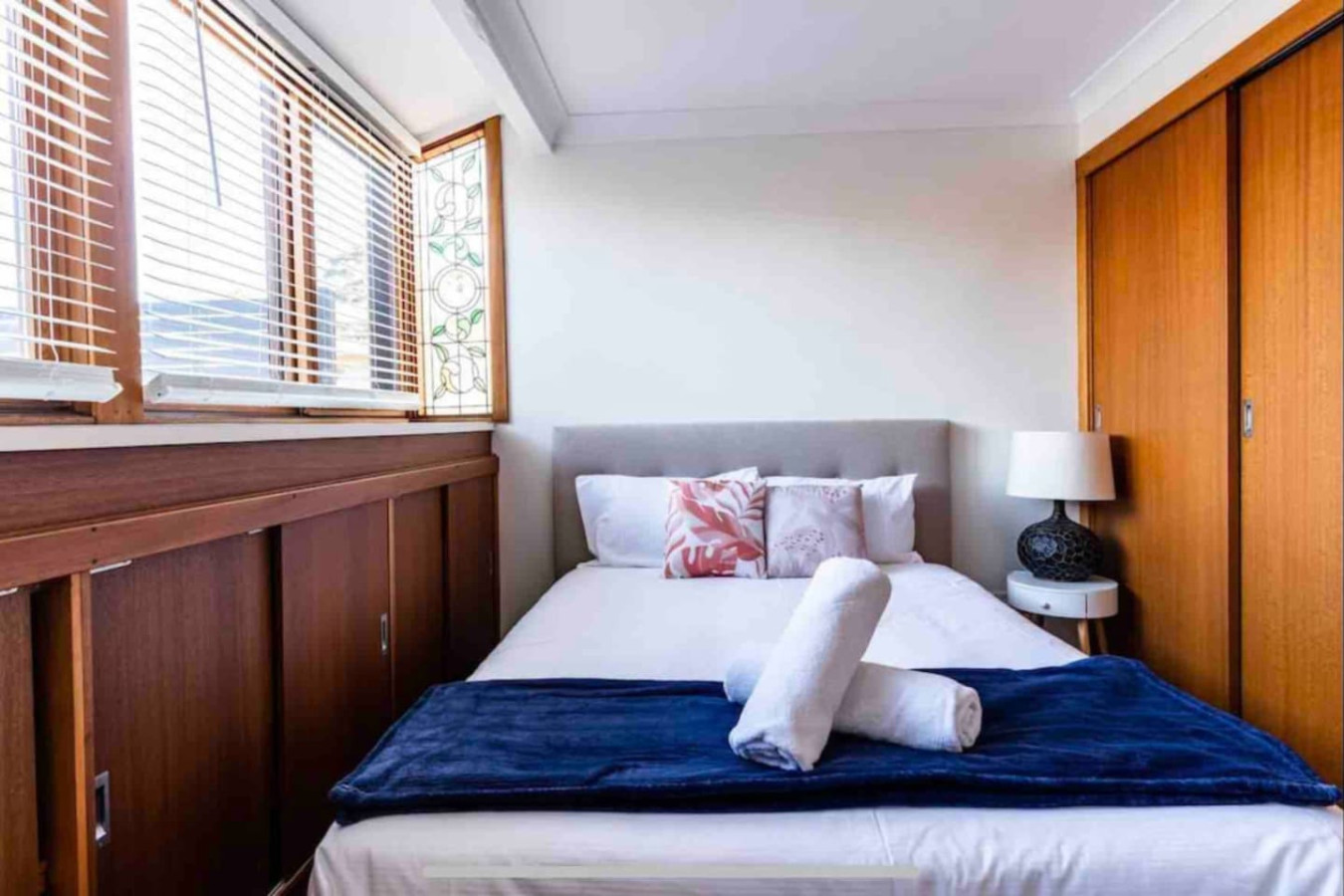 Ample natural light brightens the bedroom through its windows.