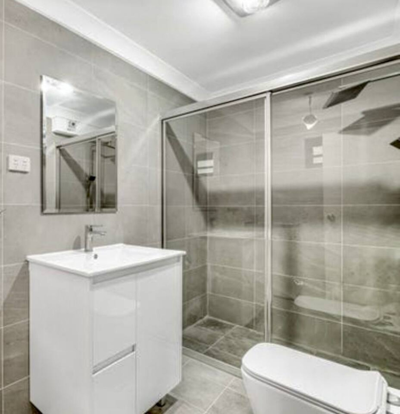 Downstairs bathroom. Which also includes a washer and dryer.