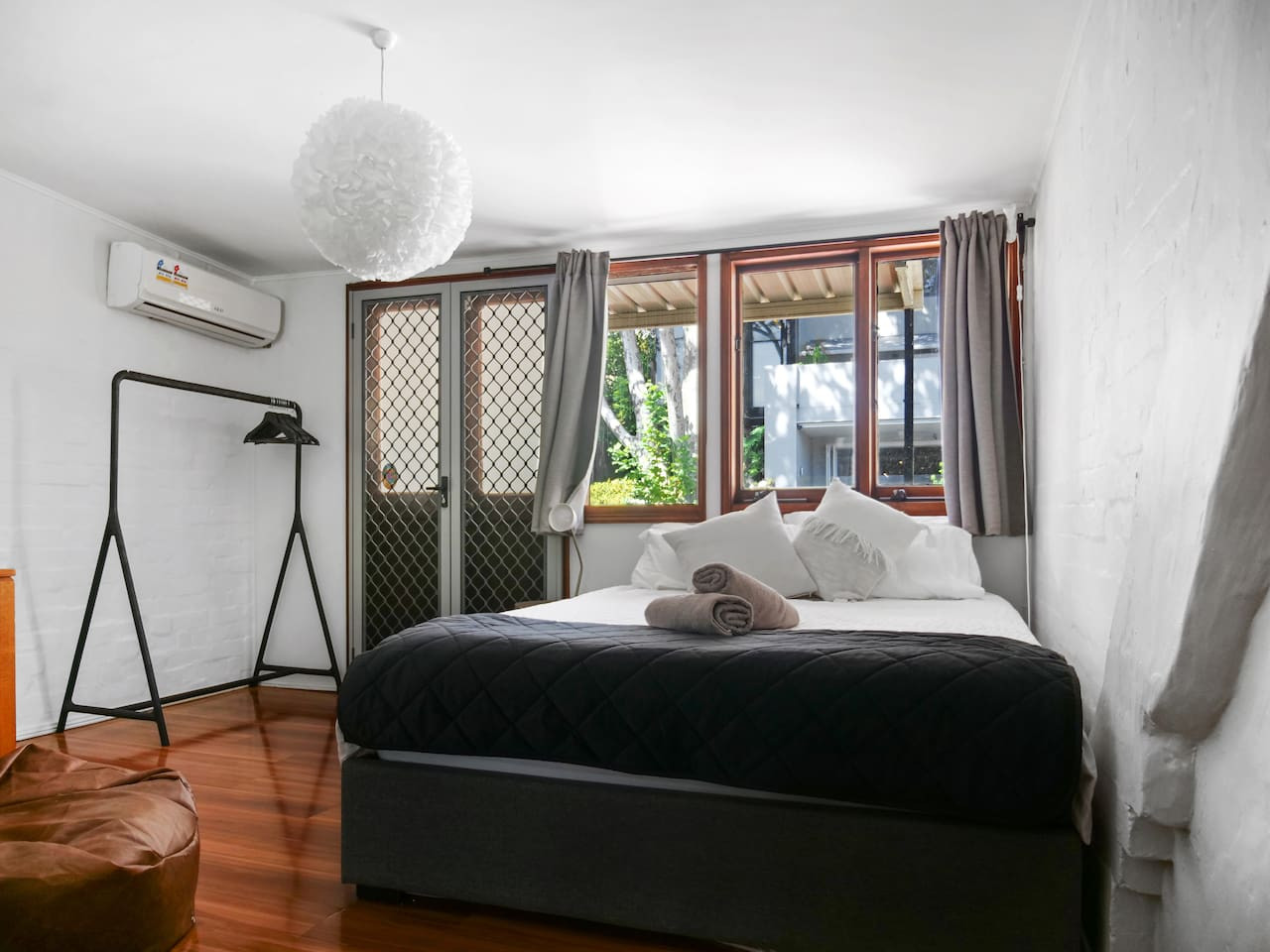 Spacious bedroom with a queen bed and stunning view.