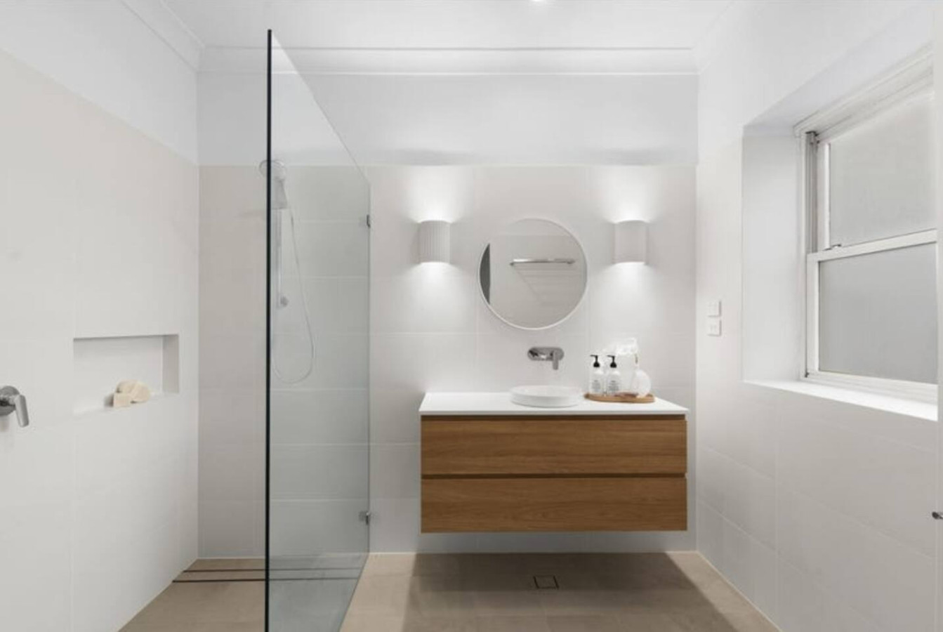 Bright, white, & modern. Refresh & rejuvenate in style. See more of this space! This is the ensuite to the main bedroom.