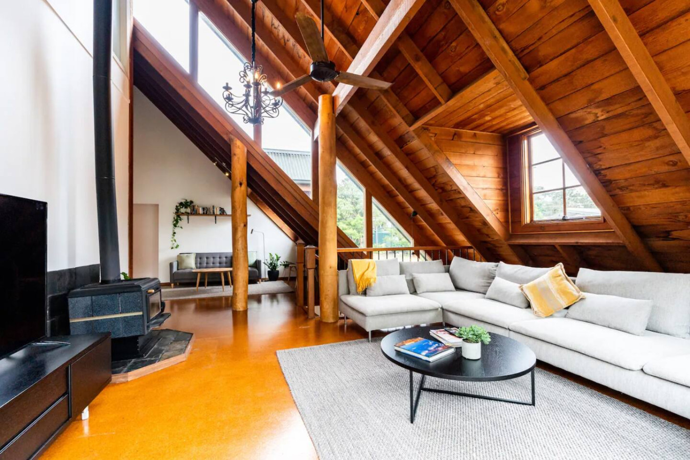 Cozy up in a living room with charming wooden features.