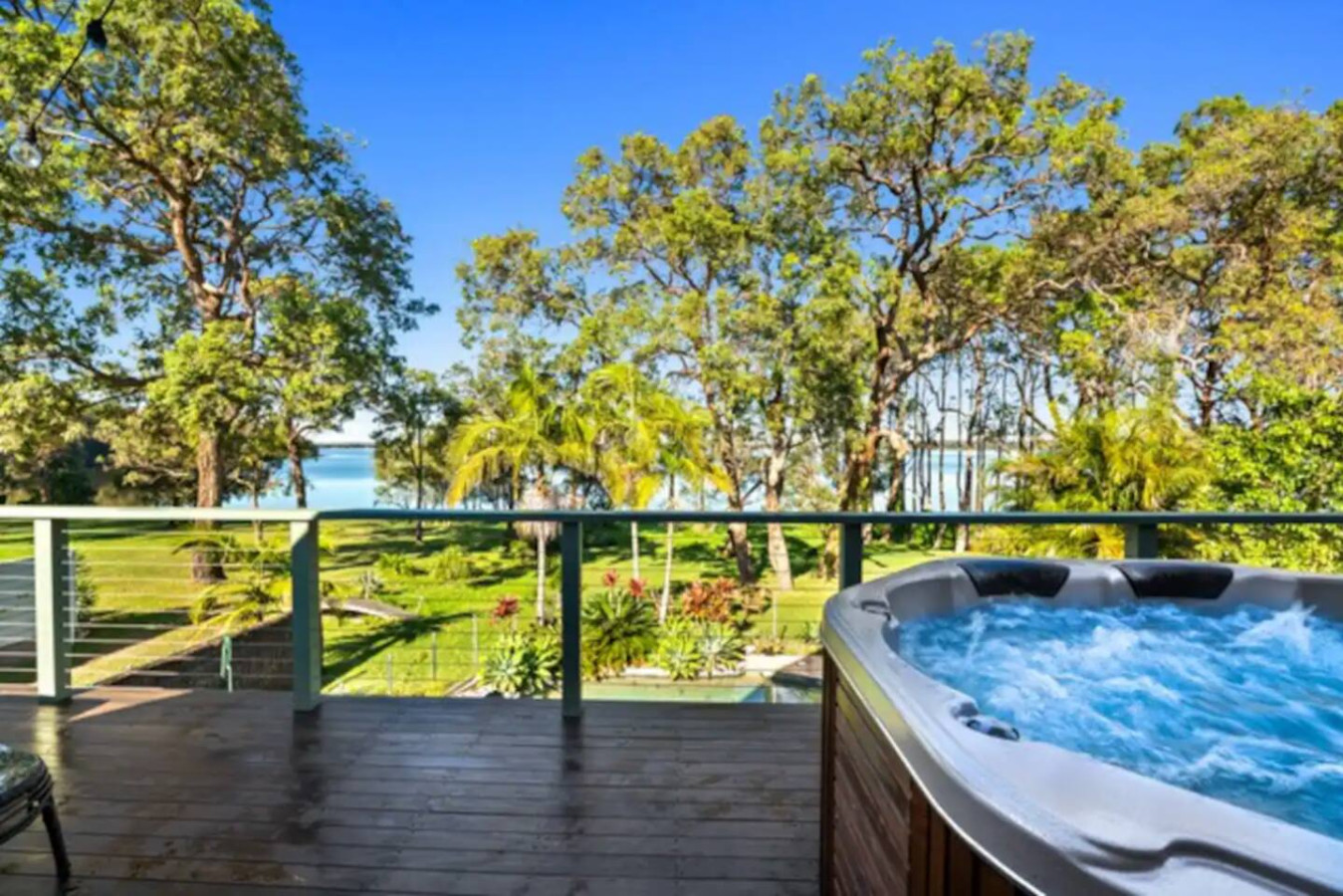 Relax in luxury on our patio with a hot tub and stunning lake view.