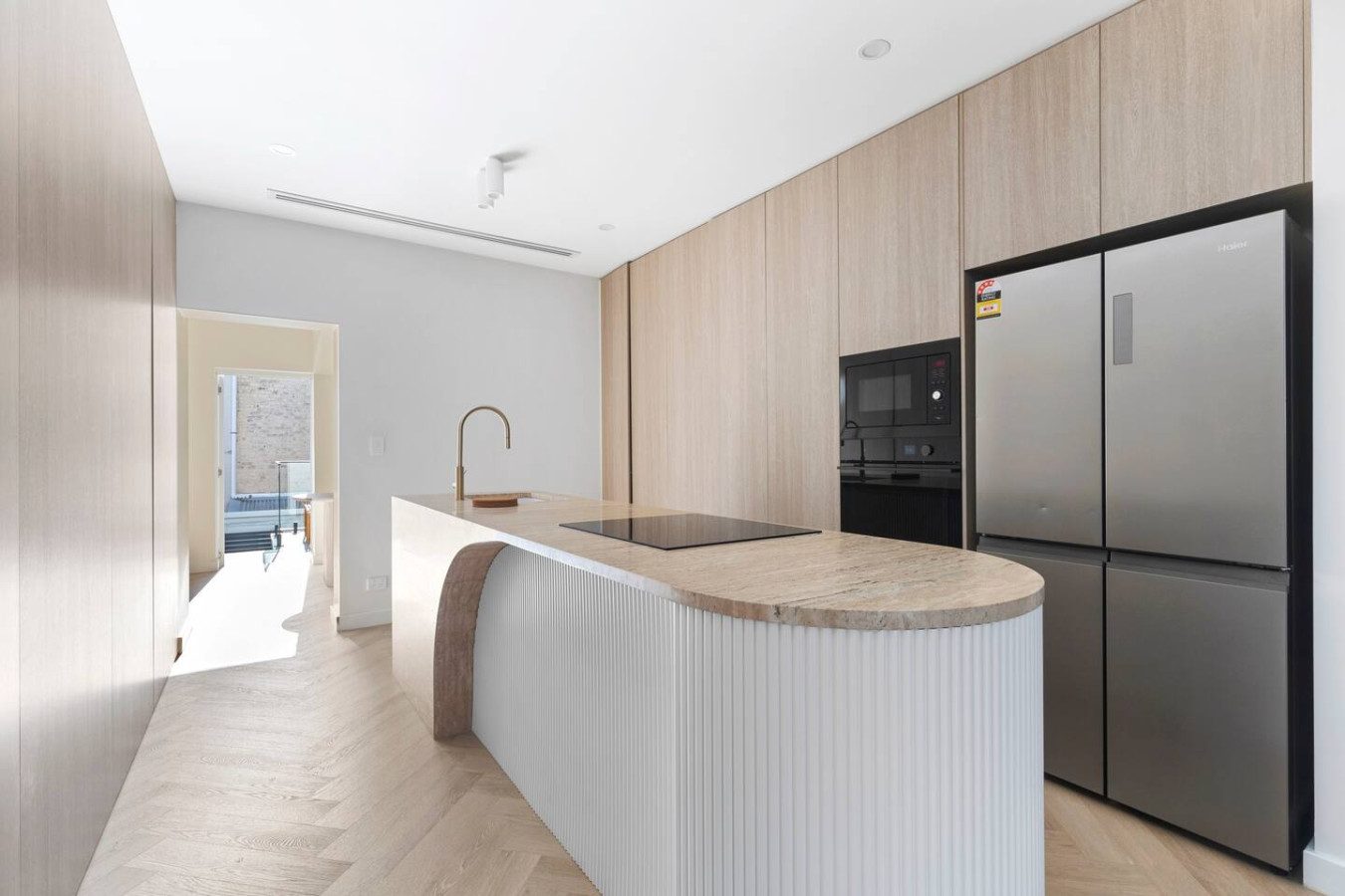 Sleek modern kitchen with high-end appliances, stylish wood finishes, and a spacious island—perfect for cooking and entertaining! By Superhostly