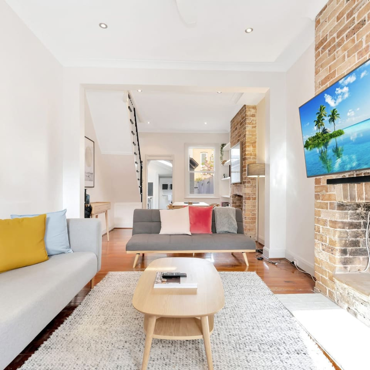 Open-plan layout with modern finishes and cozy seating – By Superhostly