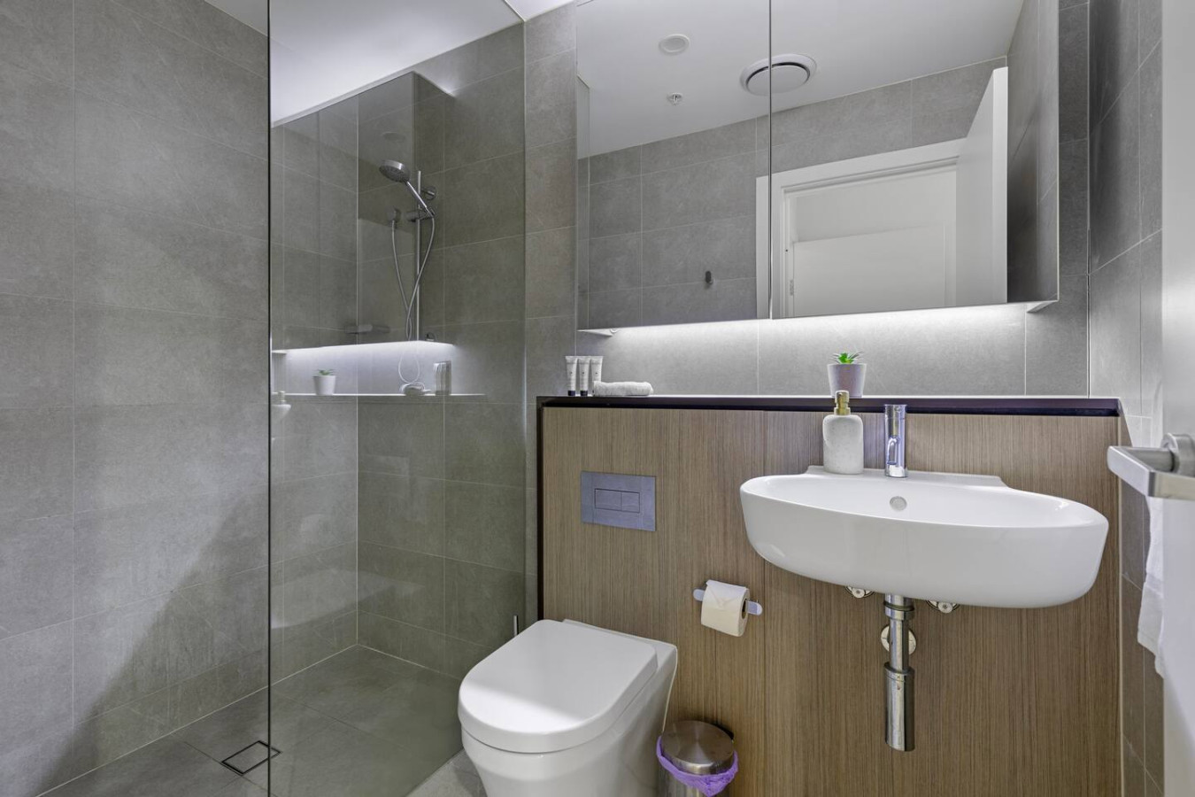 Fresh and polished bathroom with a walk-in shower and ambient lighting. By Superhostly