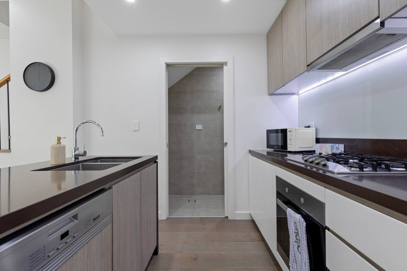 A compact and clever layout featuring a kitchen and tucked-away bathroom—perfect for long stays. By Superhostly