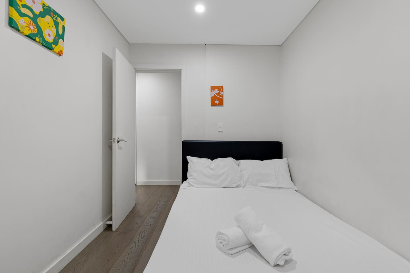 Simple and serene bedroom with outdoor access—perfect for a good night’s sleep. By Superhostly