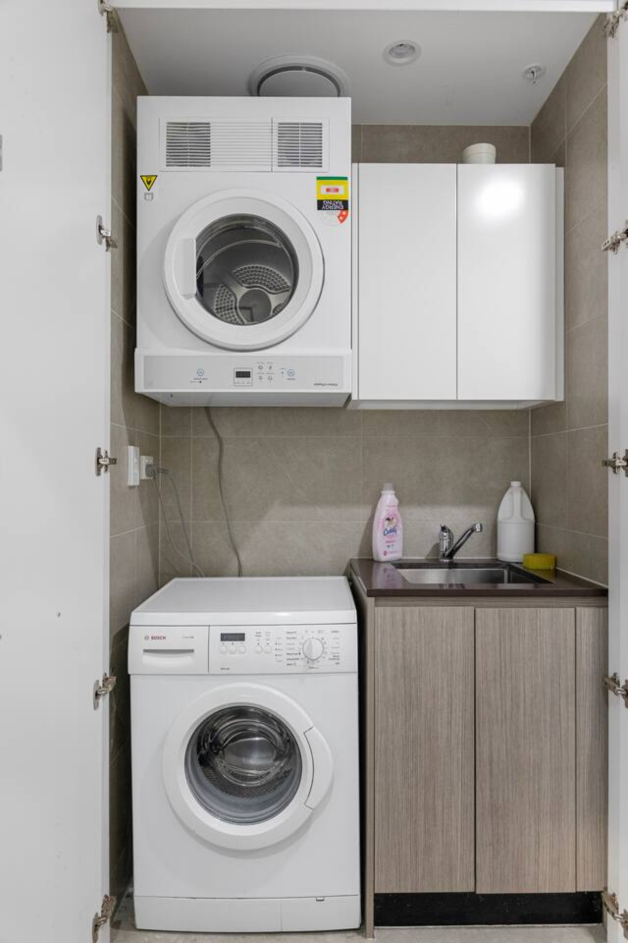 In-unit laundry with washer, dryer, sink, and storage—great for longer stays. By Superhostly