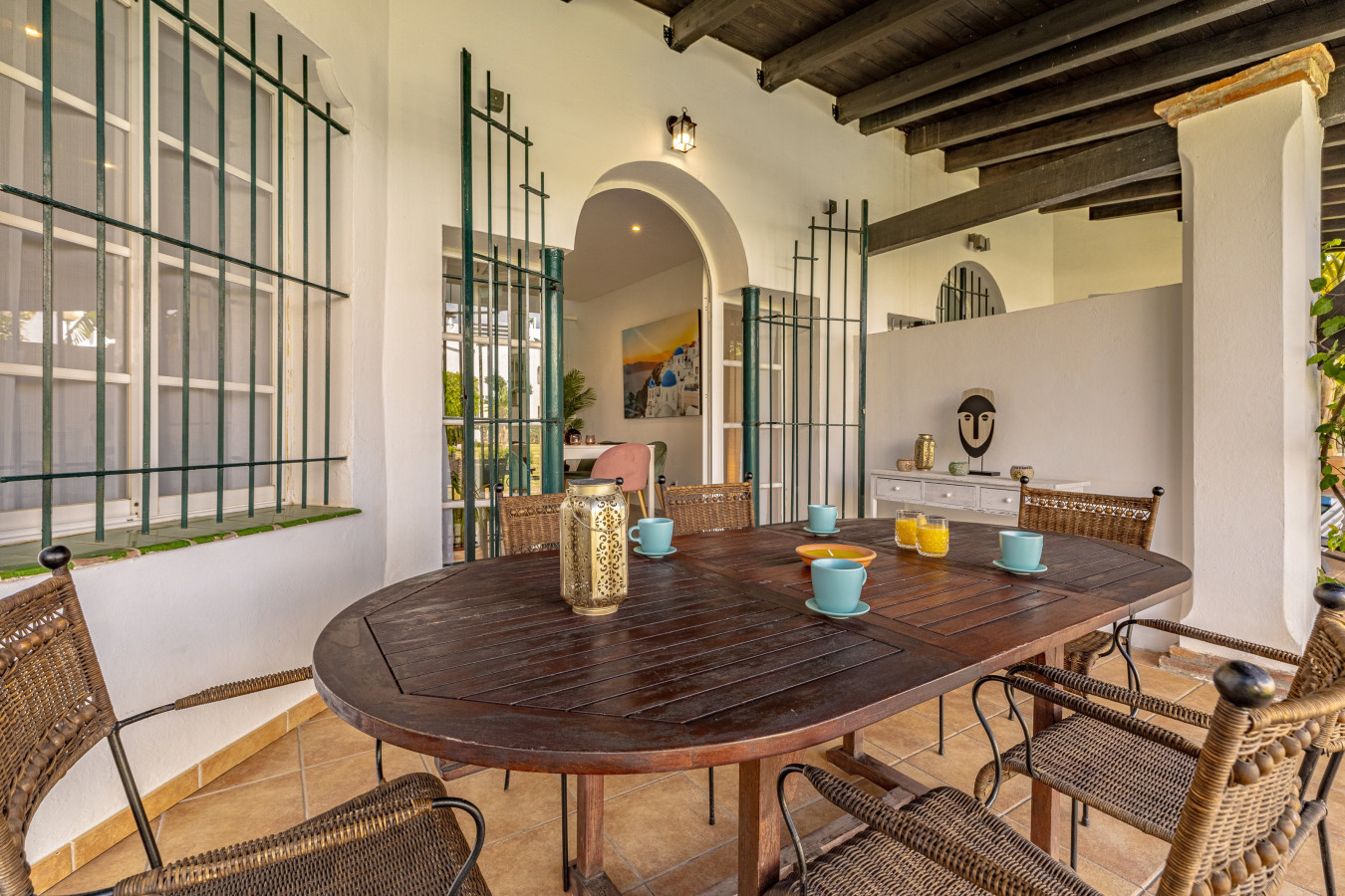 Ground floor terrace with dining area leading to the pool and gardens