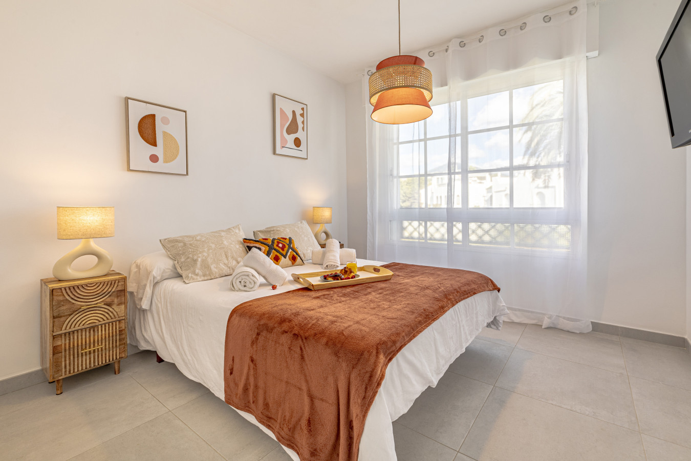 Second bedroom with double bed, TV, and pool views