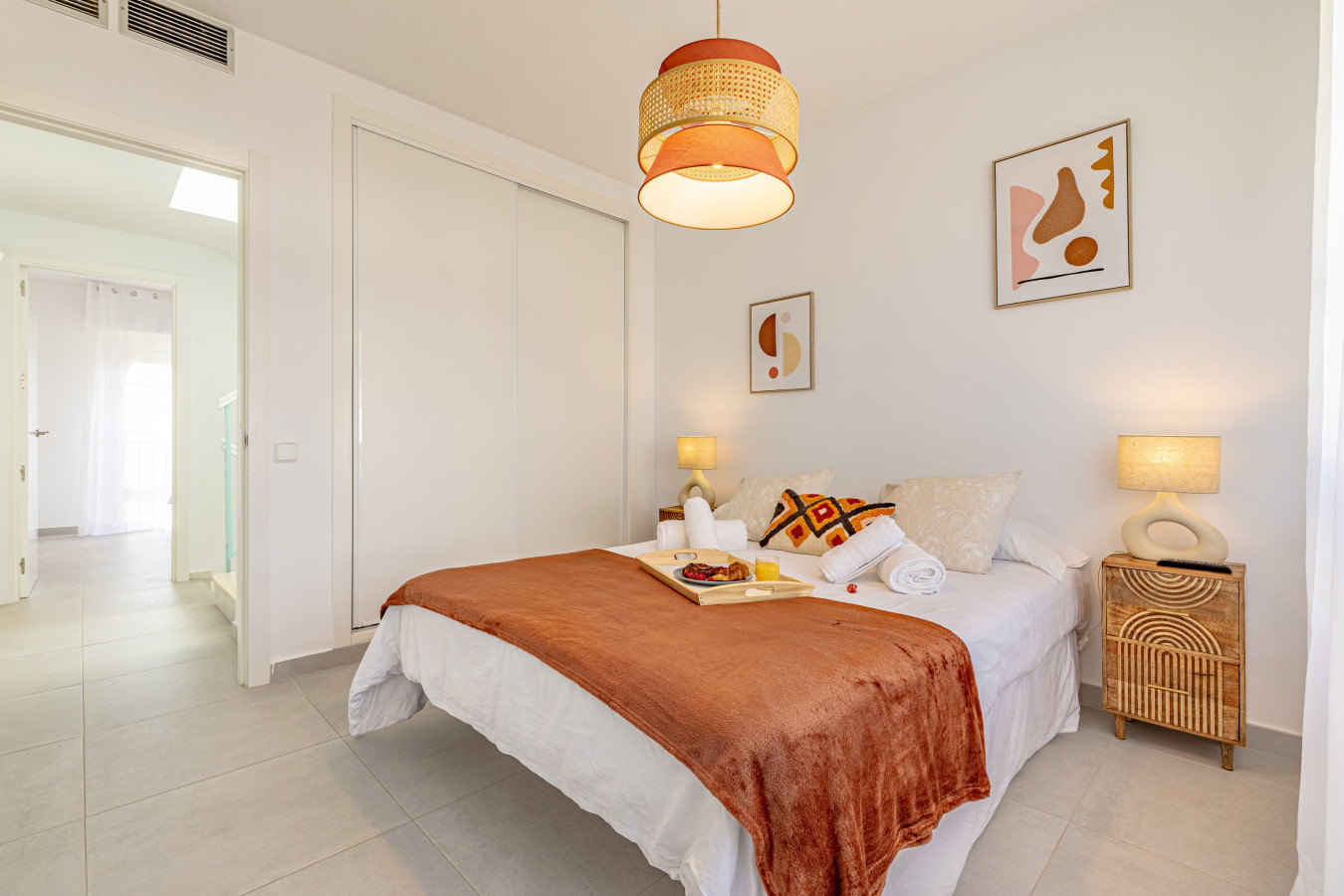 Second bedroom with double bed, TV, and pool views