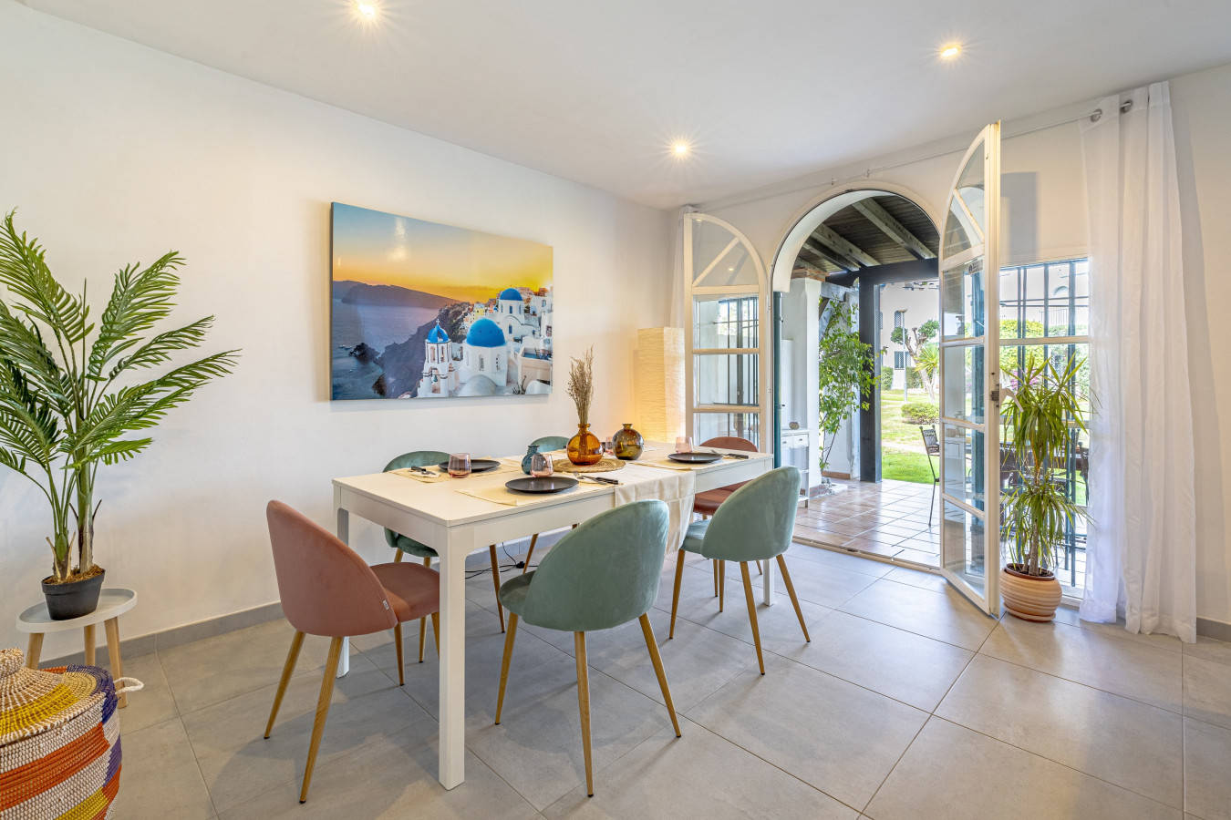 Living room 6-person dining area with glass doors leading to the terrace, pool, and gardens