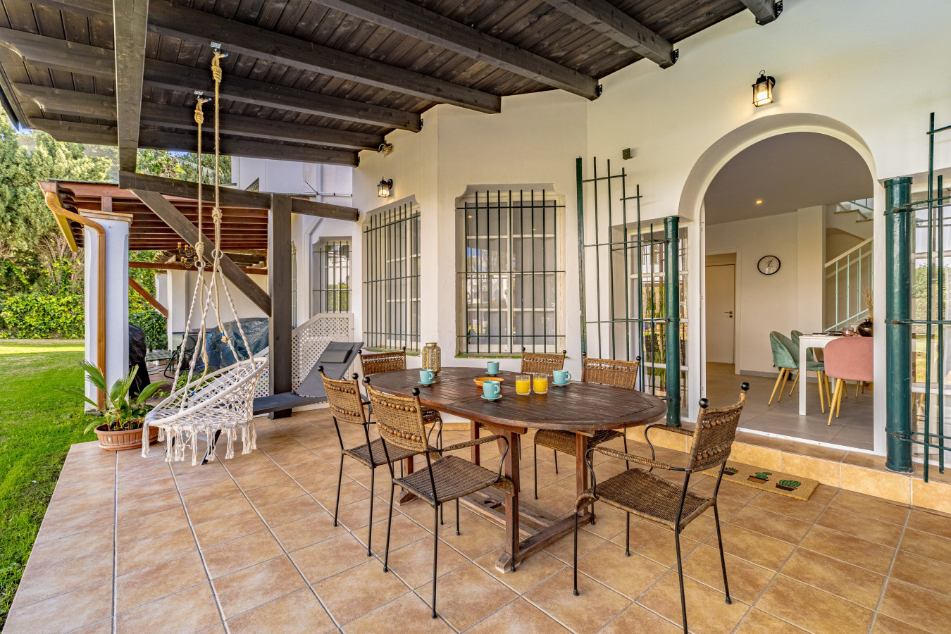 Ground floor terrace with dining area leading to the pool and gardens