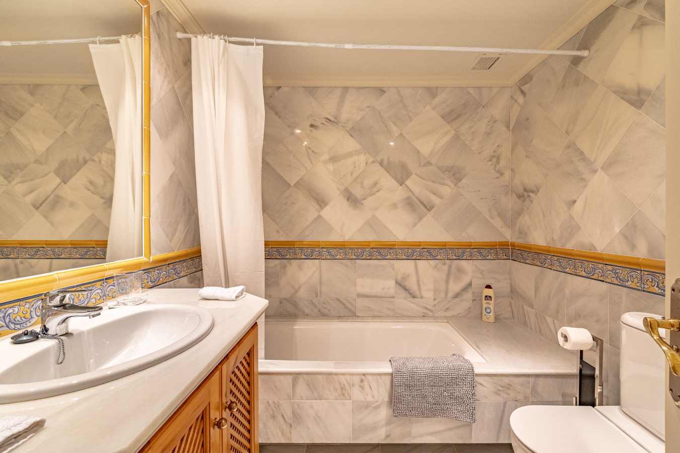 Second bedroom en-suite bathroom with shower over bath
