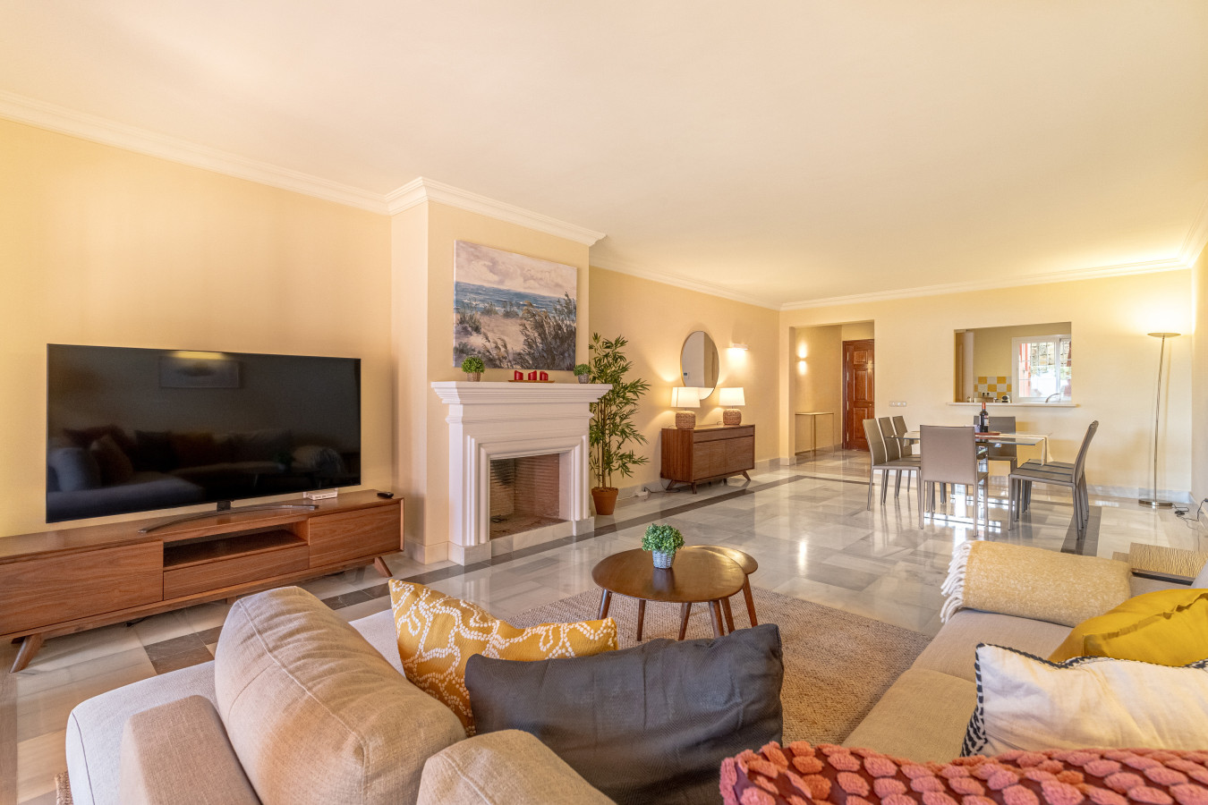 Large living room with chimney, Smart TV, seating area, dining area, French windows leading to the terrace