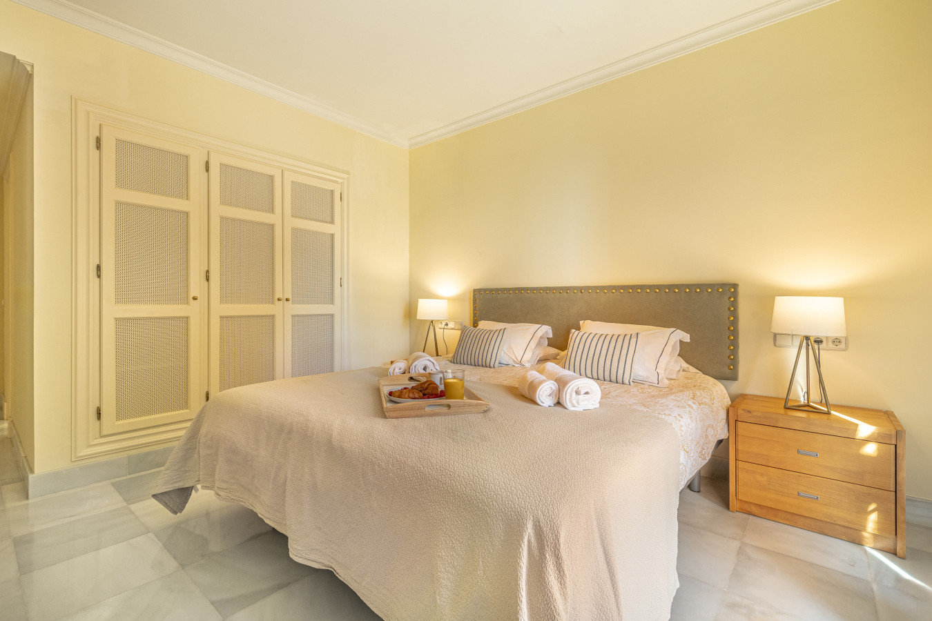 Third bedroom with double bed, en-suite bathroom, and private balcony