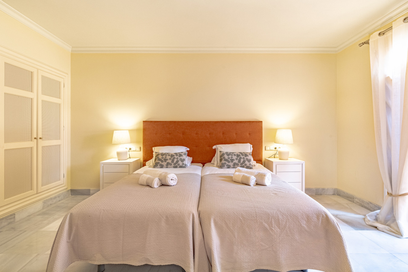 Master bedroom with twin beds, en-suite bathroom, and private terrace