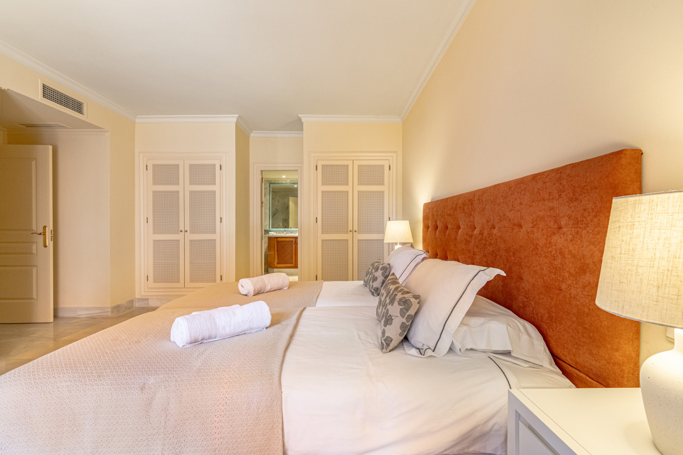 Master bedroom with twin beds, en-suite bathroom, and private terrace