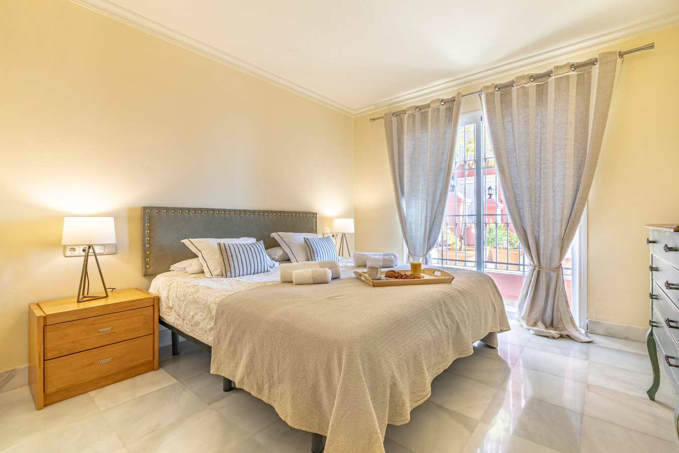 Third bedroom with double bed, en-suite bathroom, and private balcony