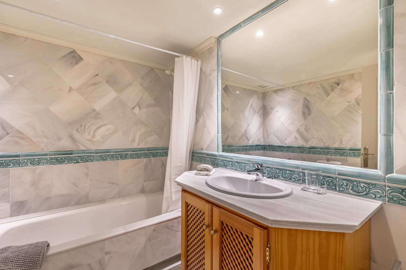 Third bedroom en-suite bathroom with shower over bath