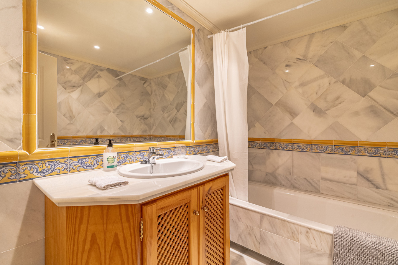 Second bedroom en-suite bathroom with shower over bath