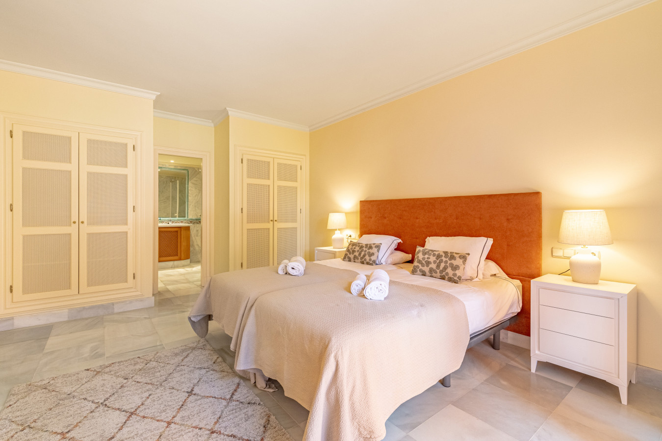 Master bedroom with twin beds, en-suite bathroom, and private terrace