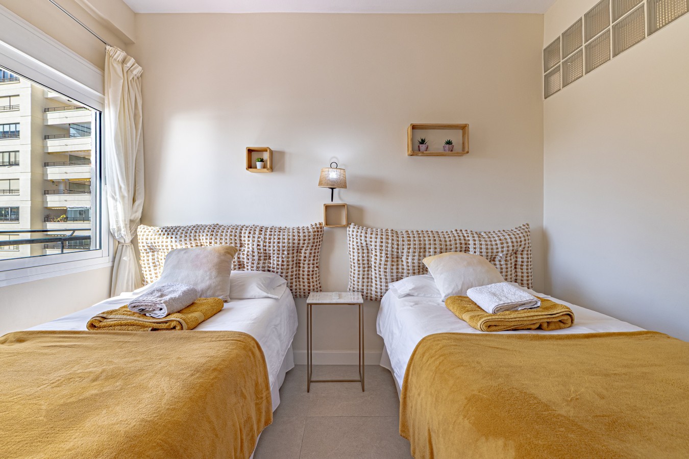Twin bedroom with fitted wardrobes and a ceiling fan