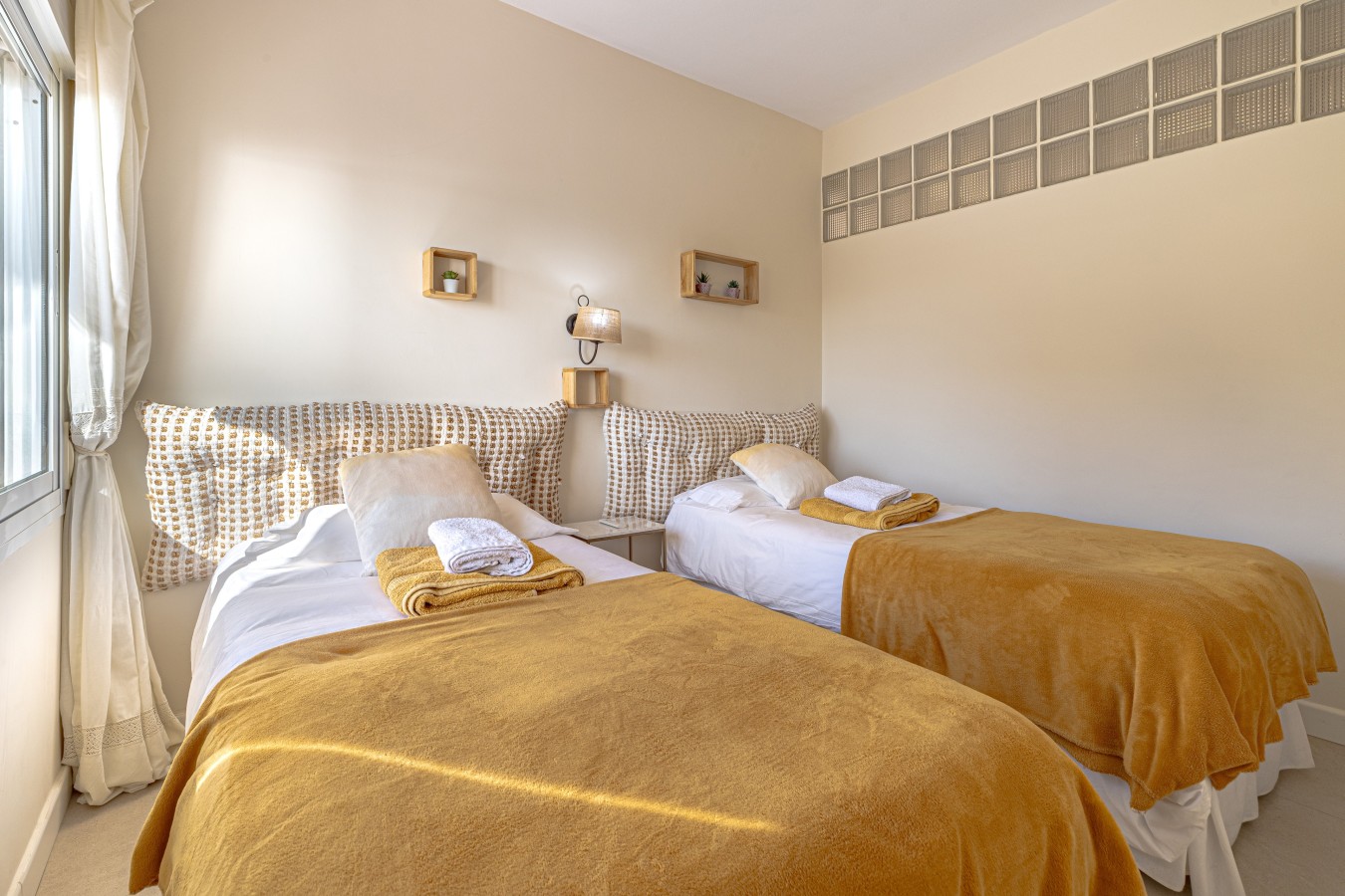 Twin beds made up with fresh linen and towels
