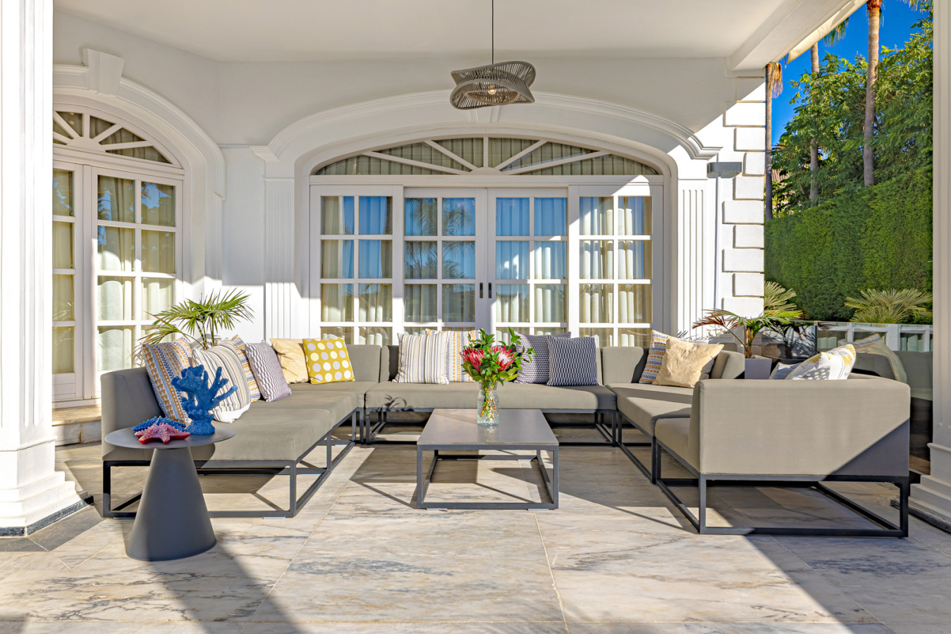 Chillout terrace outside the living room with pool, garden, and sea views
