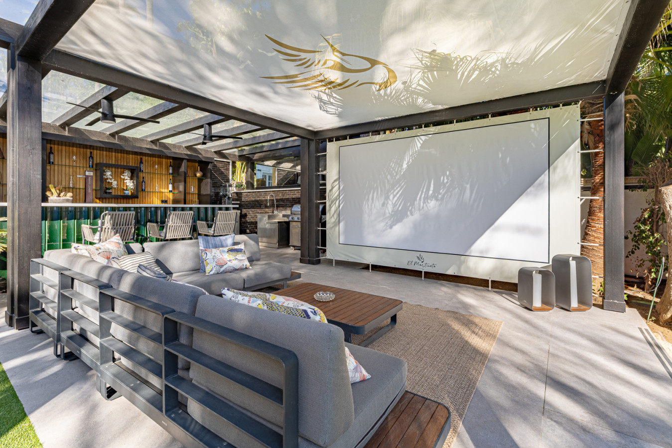 Chillout terrace with a full bar and projector screen, perfect for sunset cocktails and open-air films