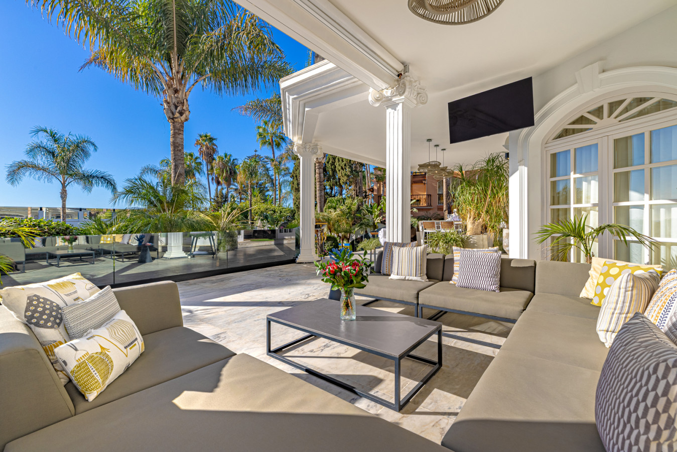 Chillout terrace outside the living room with pool, garden, and sea views
