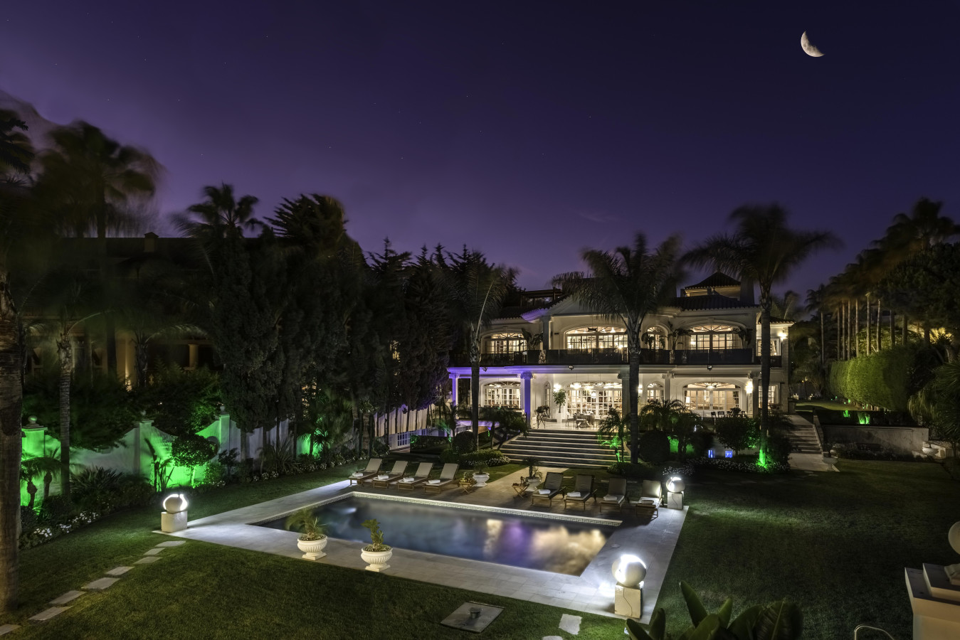 Villa El Martinete lit up facade, pool, and garden