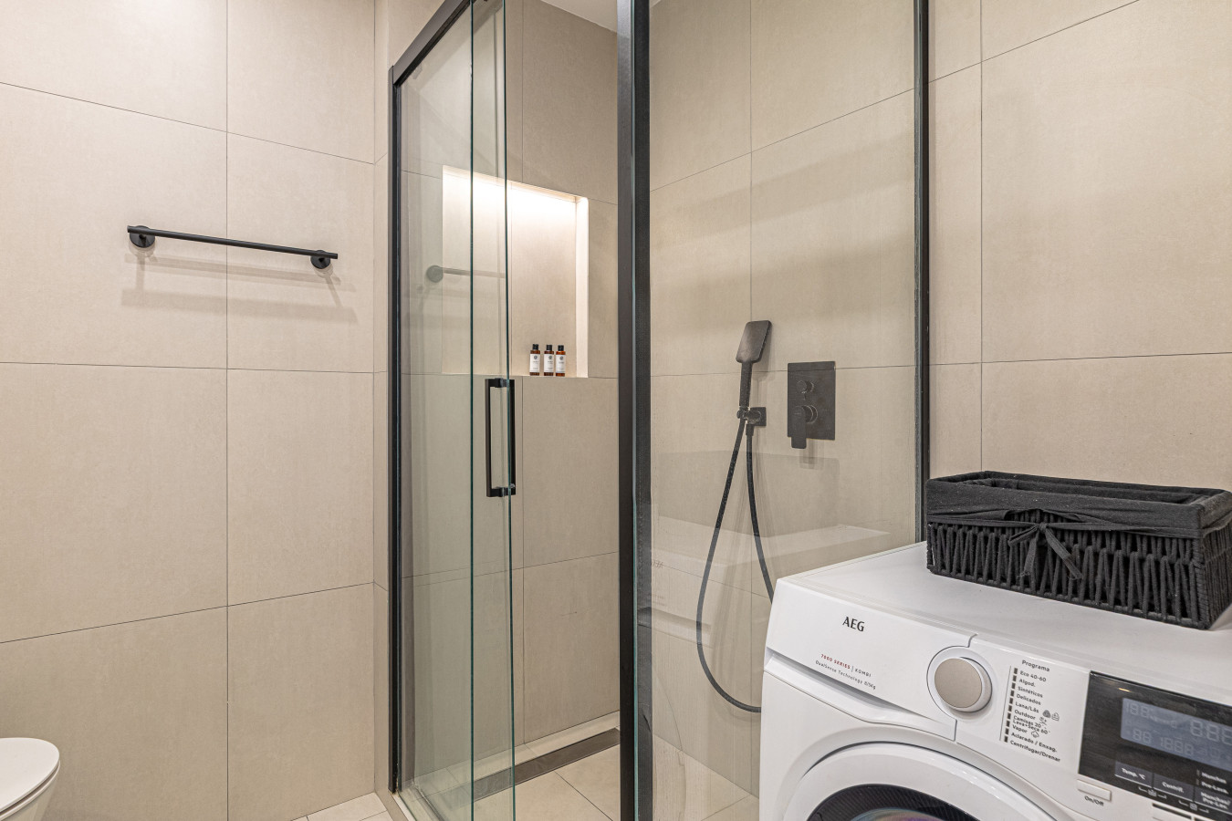Master bedroom en-suite bathroom with walk-in shower, two sinks, washing machine