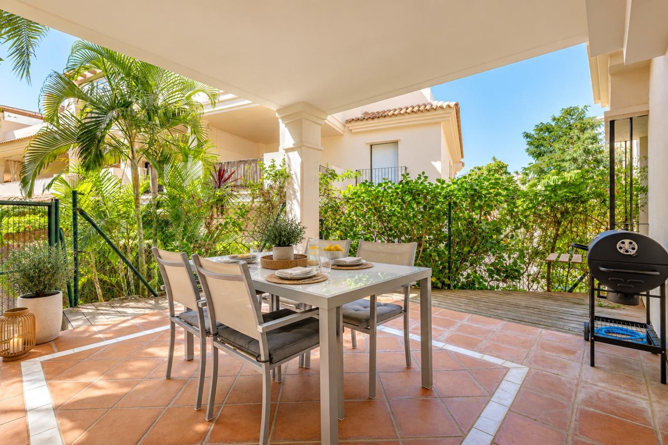 Private covered terrace with outdoor dining and BBQ, opening onto the tropical gardens