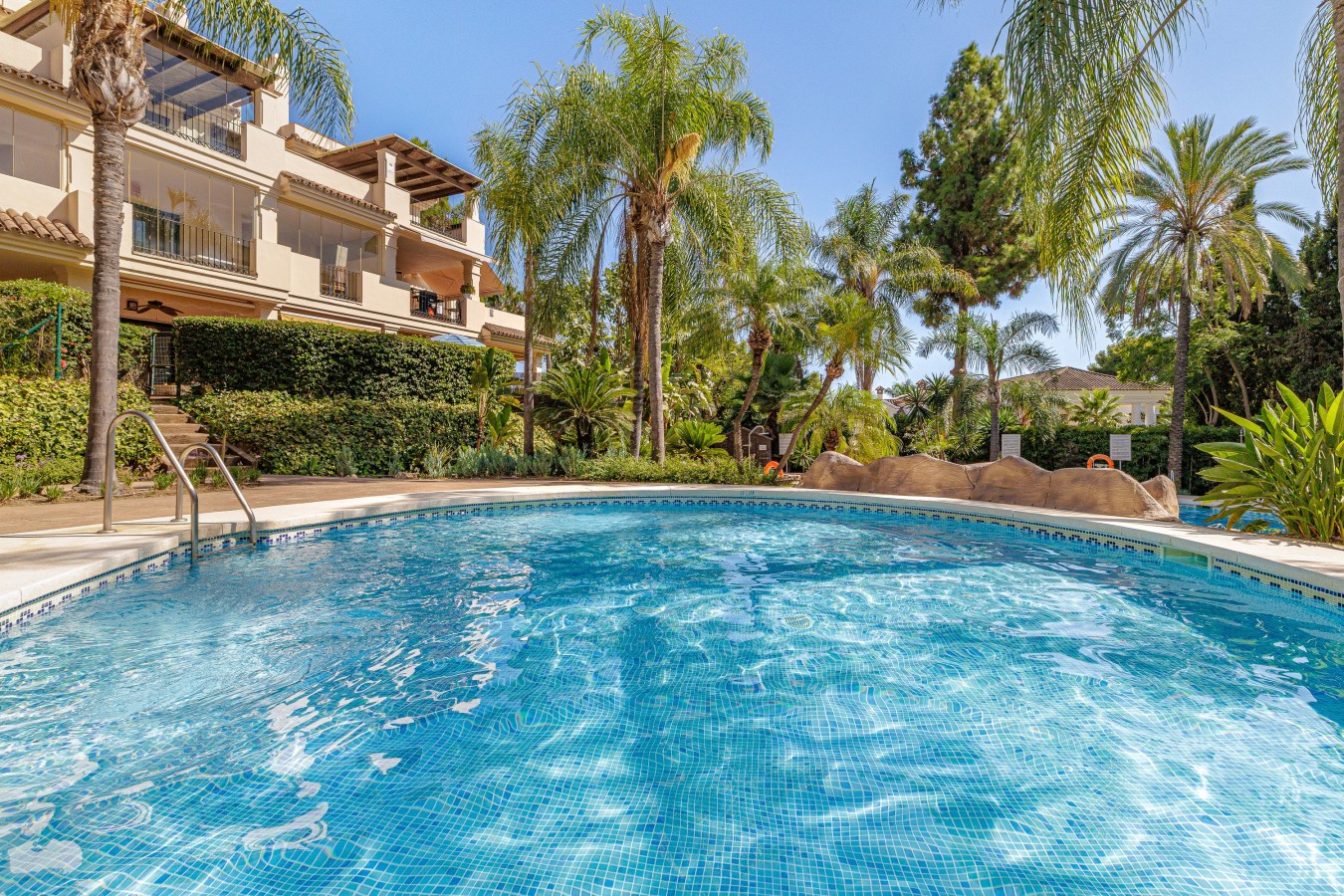 Communal pool and gardens inside the gated Hacienda El Palmeral community